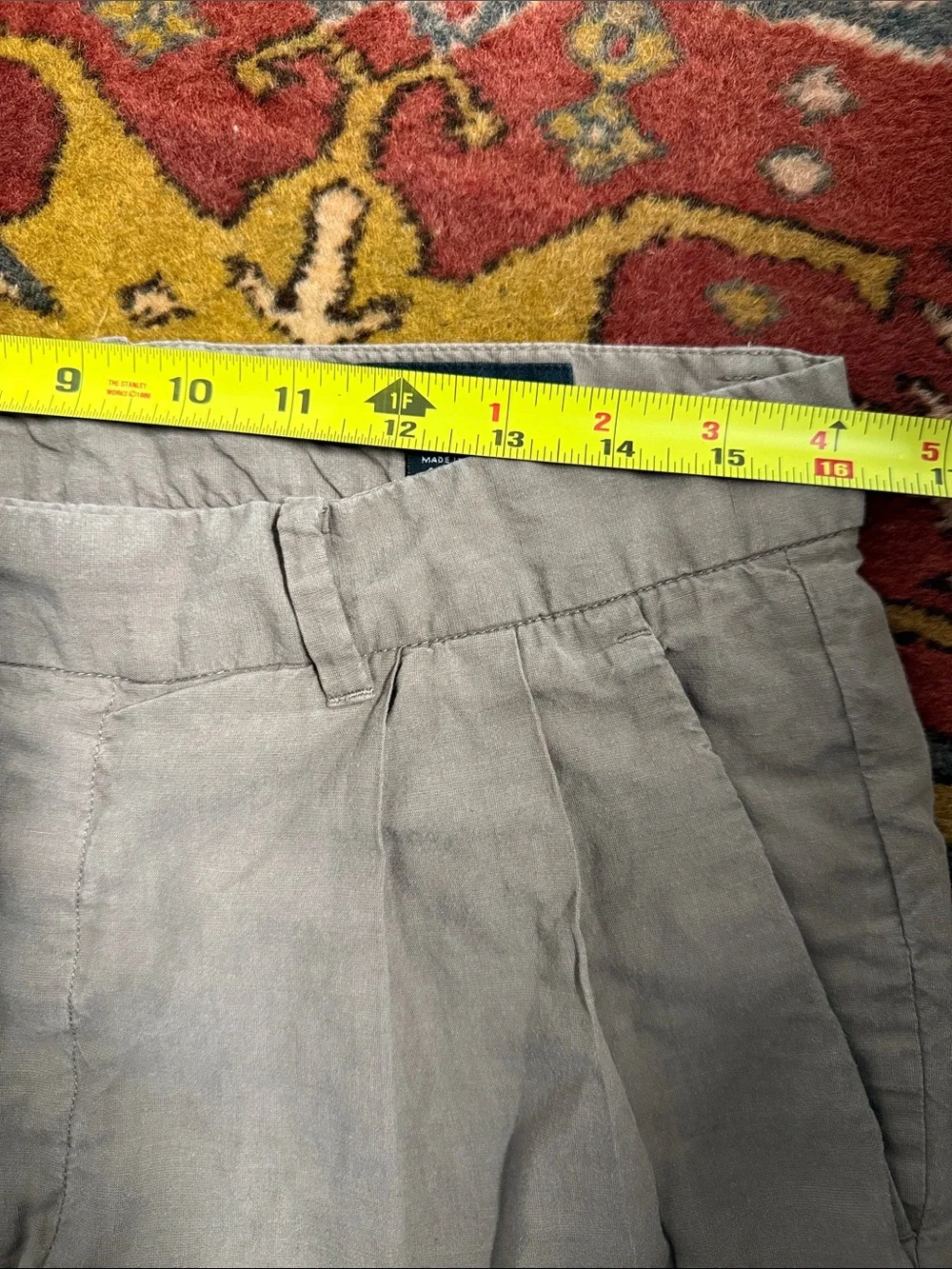 AllSaints trousers with a pleated front and a button closure